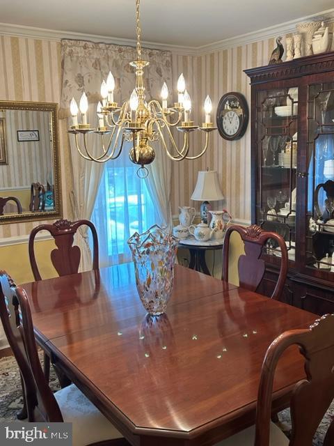 9221 Greenhouse Cir, Nottingham, MD 21236 - dining room with wallpapered walls, a chandelier, and crown molding