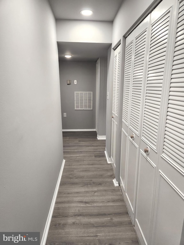 corridor with dark wood-type flooring