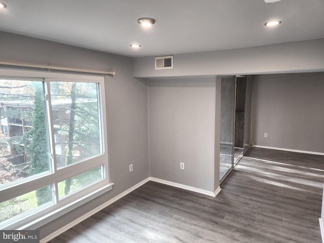 unfurnished room featuring dark hardwood / wood-style flooring