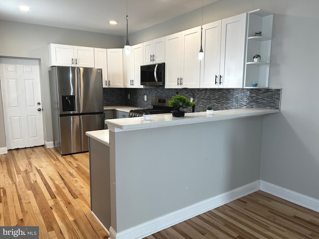 365 Union Aly, Pottstown, PA 19464 - kitchen featuring appliances with stainless steel finishes, a peninsula, light wood-type flooring, tasteful backsplash, and open shelves