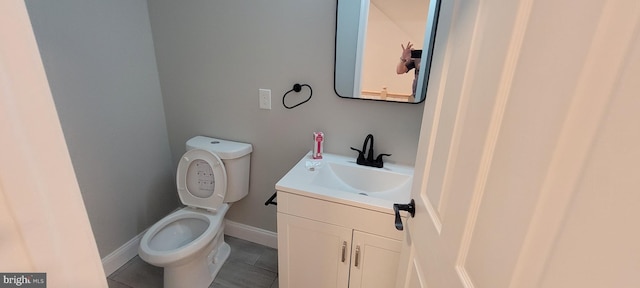 bathroom featuring toilet, tile patterned floors, and vanity