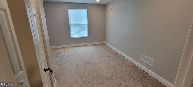 unfurnished room featuring plenty of natural light