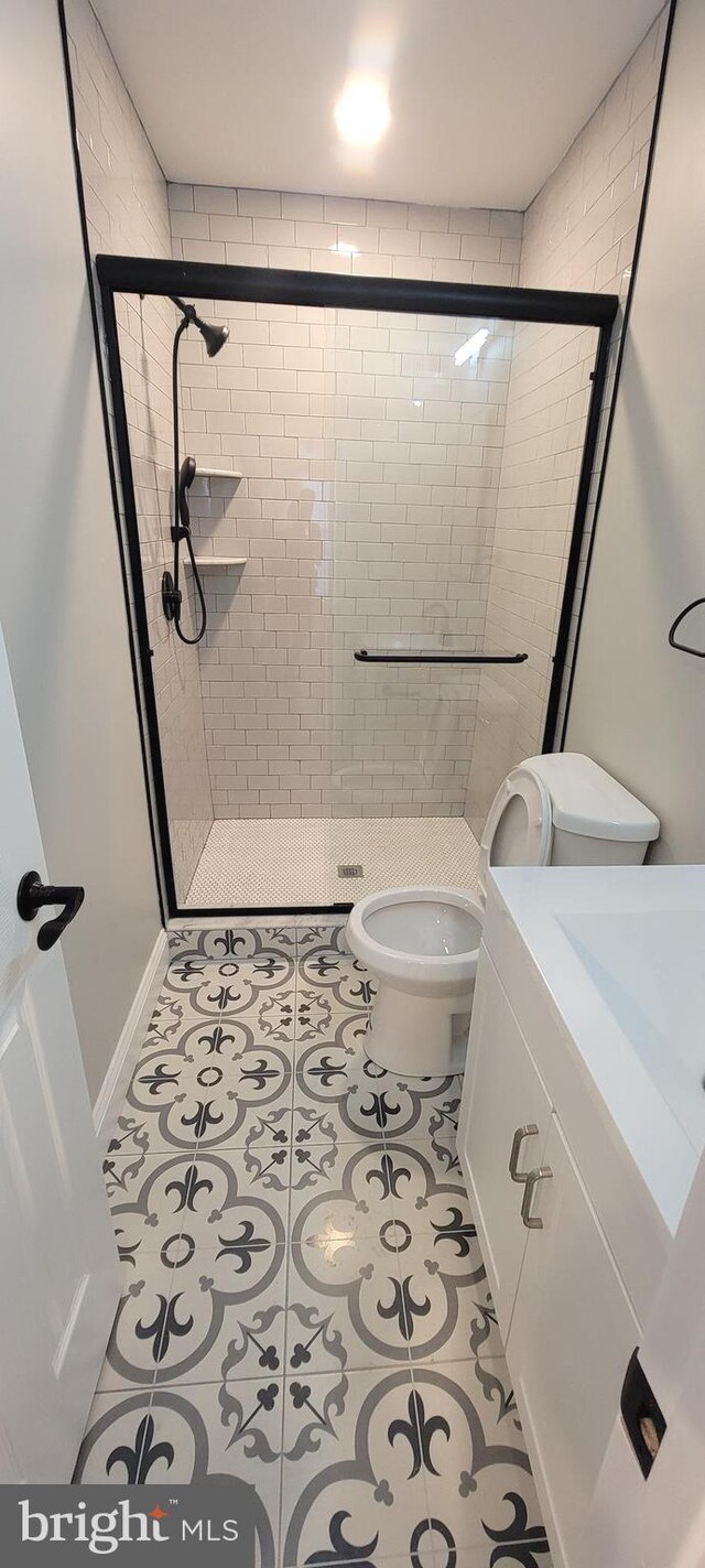 365 Union Aly, Pottstown, PA 19464 - bathroom featuring toilet, a shower stall, vanity, and tile patterned floors