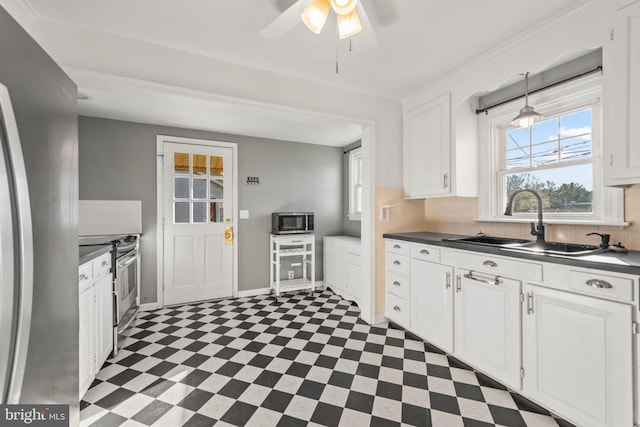 kitchen featuring ceiling fan, sink, white cabinetry, and stainless steel appliances