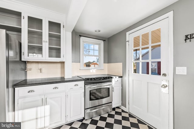 kitchen featuring white cabinetry, electric stove, and backsplash