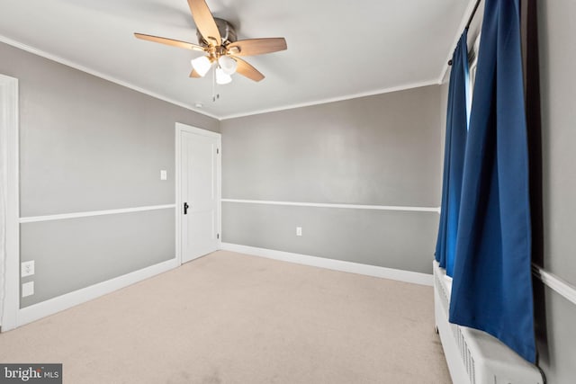 unfurnished room with carpet flooring, ceiling fan, and ornamental molding