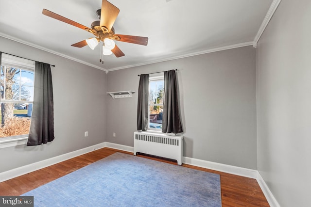 empty room with radiator, ceiling fan, hardwood / wood-style floors, and ornamental molding