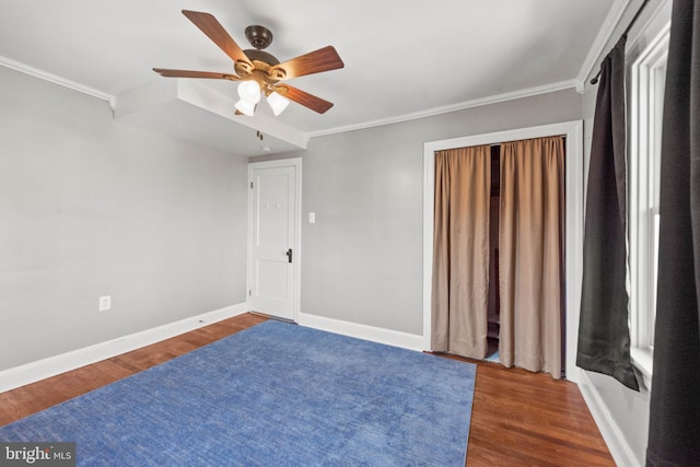 bedroom with dark hardwood / wood-style floors, ceiling fan, and crown molding