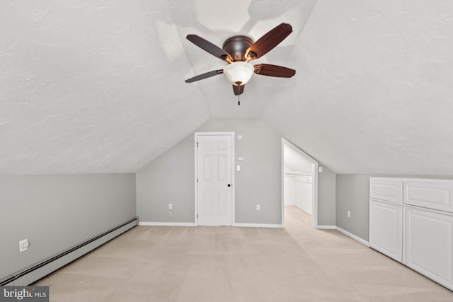 bonus room with light carpet, a textured ceiling, ceiling fan, a baseboard radiator, and lofted ceiling