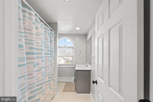 bathroom with vanity and baseboard heating