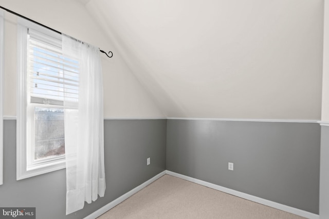 bonus room with carpet flooring and lofted ceiling