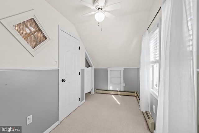 bonus room with baseboard heating, ceiling fan, light colored carpet, and vaulted ceiling