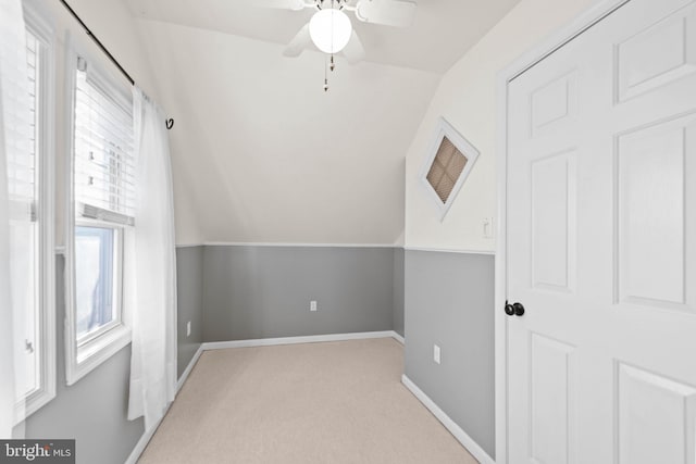 bonus room featuring ceiling fan, light carpet, and vaulted ceiling