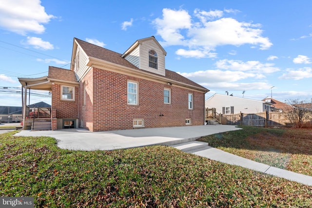 view of side of property with a yard and a patio