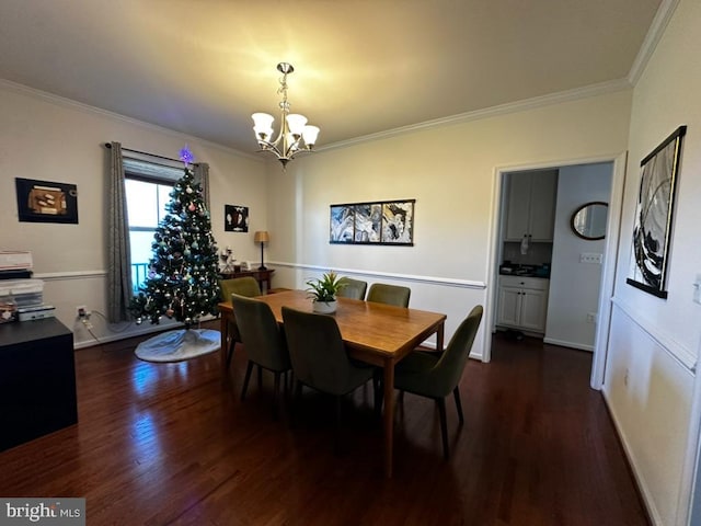 dining room with a notable chandelier, crown molding, and dark wood-type flooring