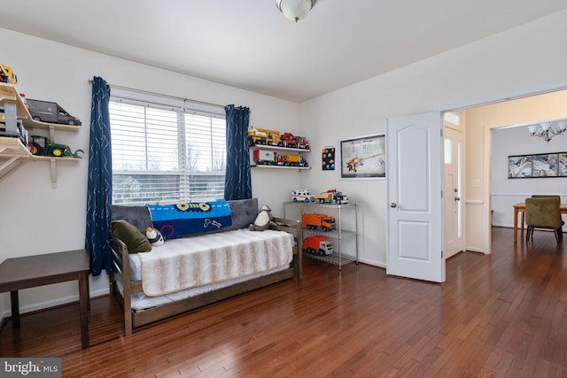 bedroom with dark hardwood / wood-style flooring