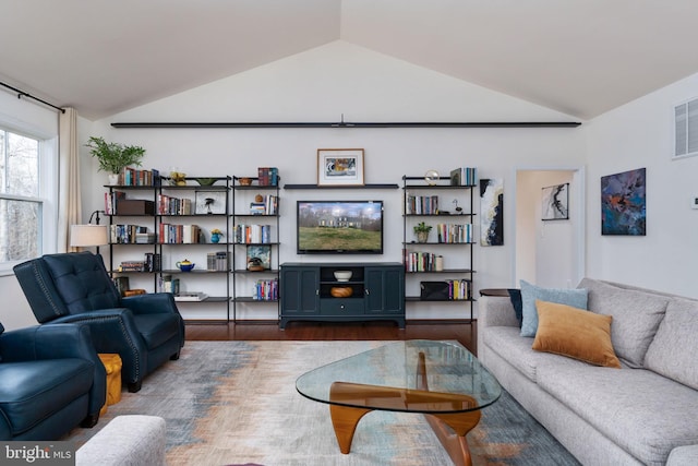 living room featuring dark hardwood / wood-style flooring and vaulted ceiling