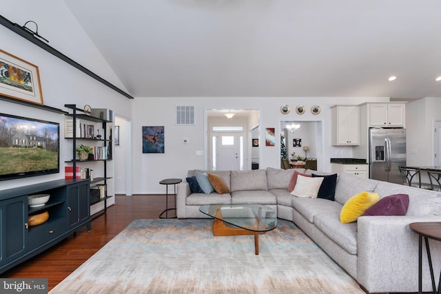 living room featuring dark hardwood / wood-style flooring and lofted ceiling