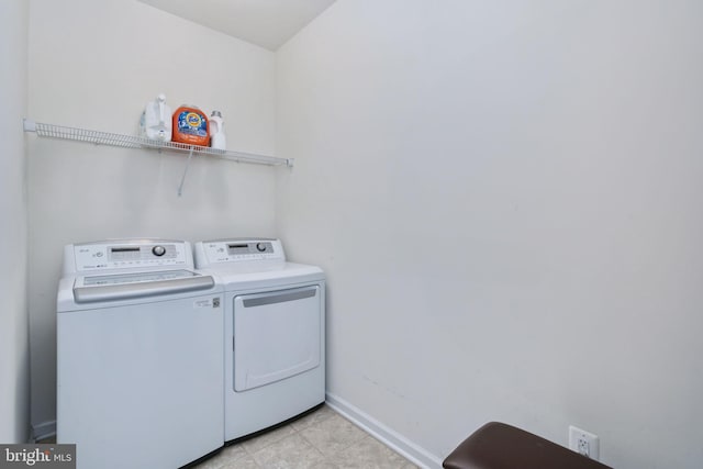 laundry room featuring washing machine and clothes dryer