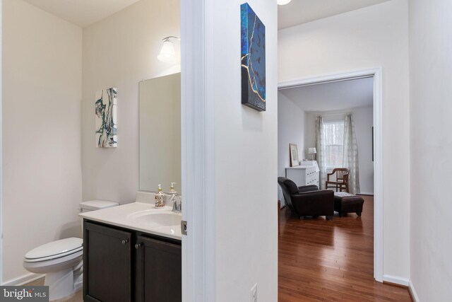 bathroom with vanity, hardwood / wood-style flooring, and toilet