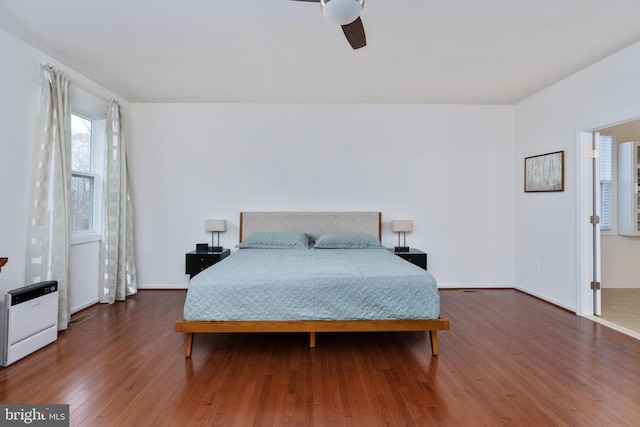 bedroom with ceiling fan and dark wood-type flooring