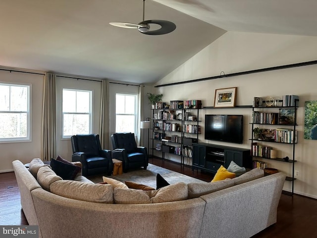 living room featuring plenty of natural light, dark hardwood / wood-style floors, ceiling fan, and vaulted ceiling