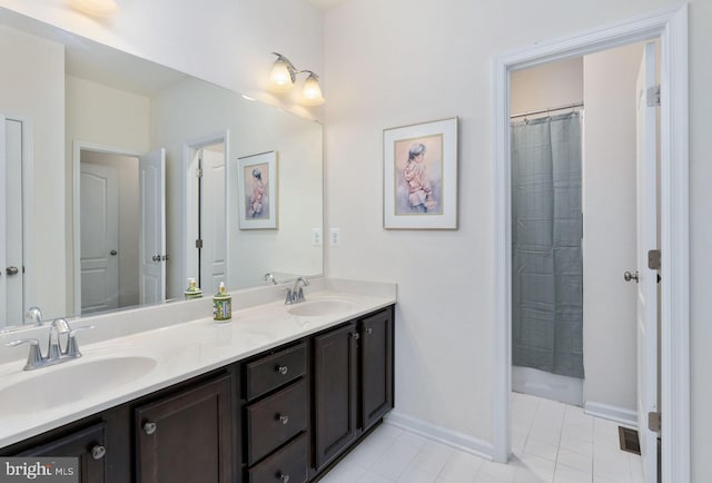 bathroom featuring tile patterned flooring, vanity, and curtained shower