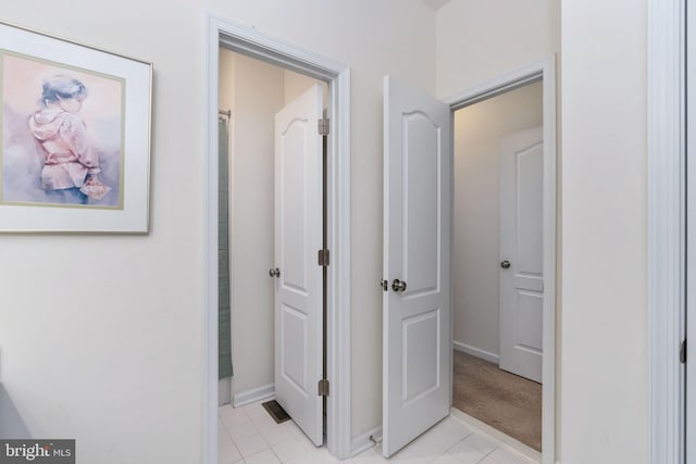 hallway featuring light tile patterned flooring