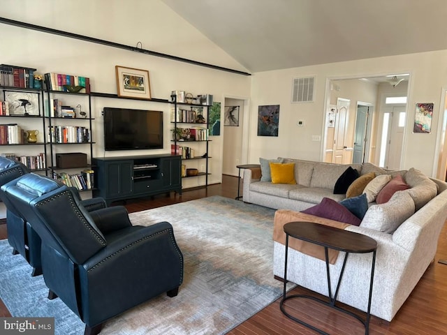 living room featuring dark hardwood / wood-style flooring and lofted ceiling