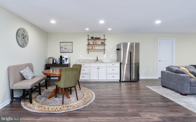 dining room with dark hardwood / wood-style flooring and indoor wet bar