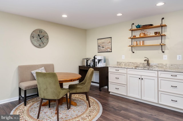 dining space featuring dark hardwood / wood-style floors and sink