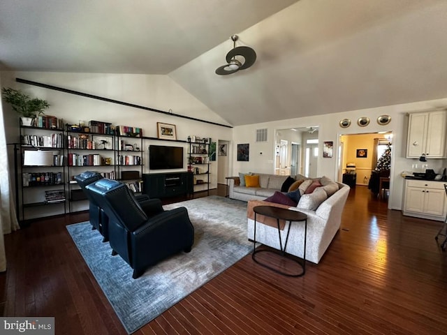 living room featuring dark hardwood / wood-style flooring and lofted ceiling