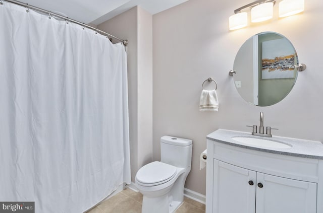 bathroom featuring toilet, vanity, and tile patterned floors