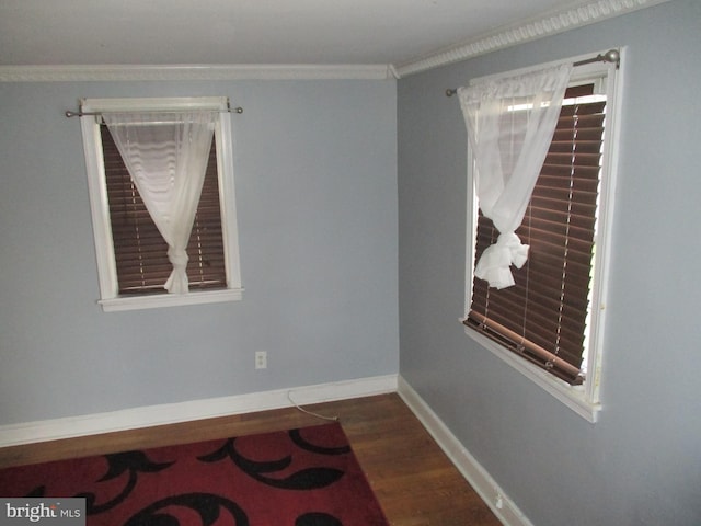 empty room with ornamental molding and dark wood-type flooring