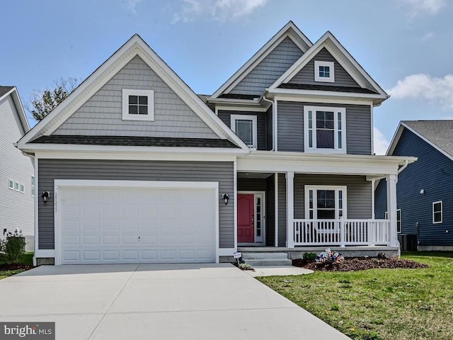 craftsman inspired home featuring a front yard, a porch, a garage, and central AC unit