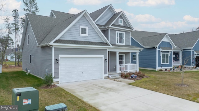 craftsman-style home with a porch, a garage, and a front yard