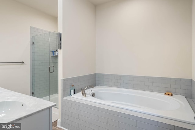 bathroom featuring vanity and separate shower and tub