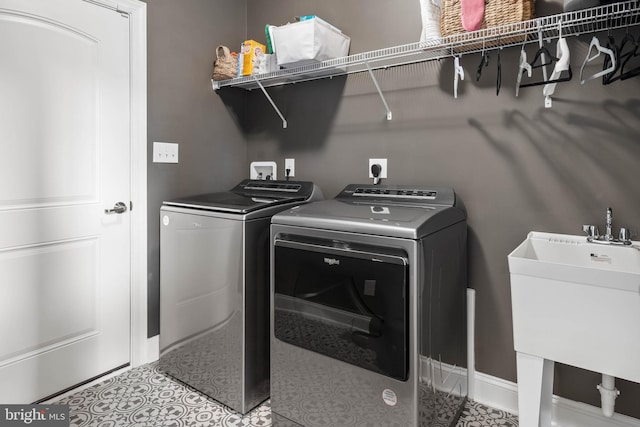 washroom with washer and dryer and sink