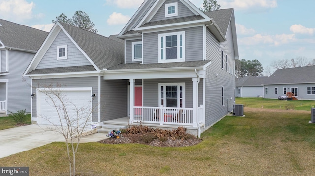 view of front of house with covered porch, a front lawn, a garage, and cooling unit