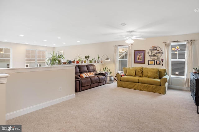 living room with ceiling fan and light colored carpet