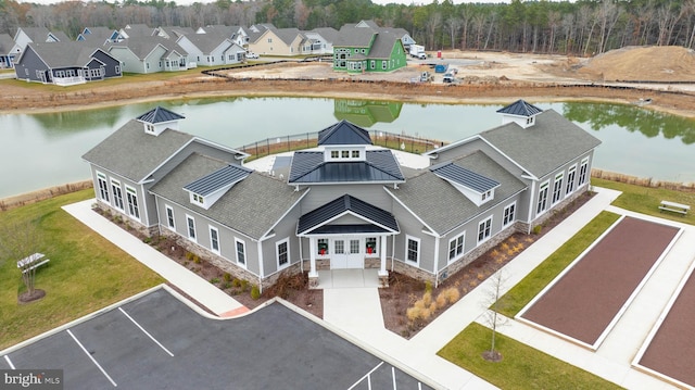 birds eye view of property with a water view