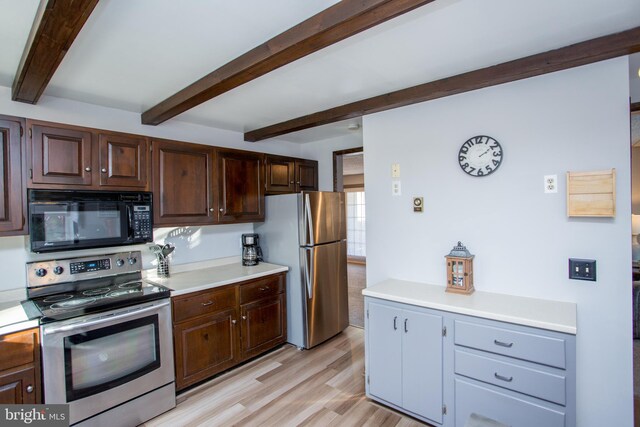 kitchen with stainless steel appliances, light wood-style floors, beamed ceiling, and light countertops
