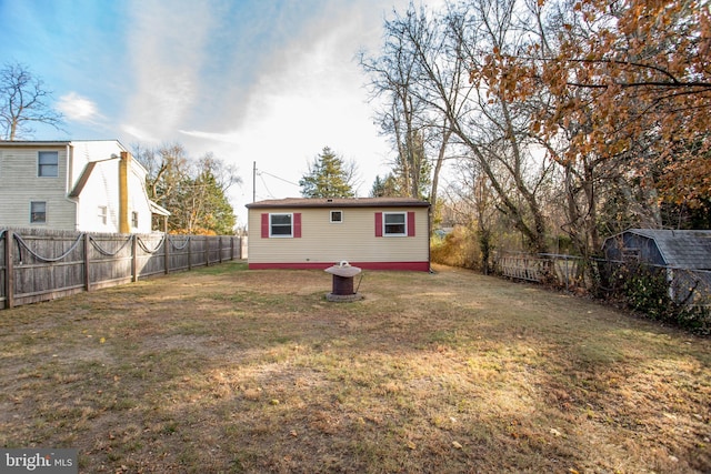 view of yard with an outbuilding and a fenced backyard