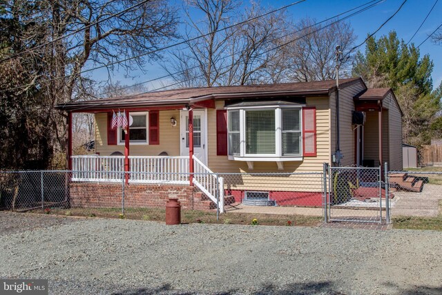 bungalow-style house featuring a fenced front yard, a porch, and a gate