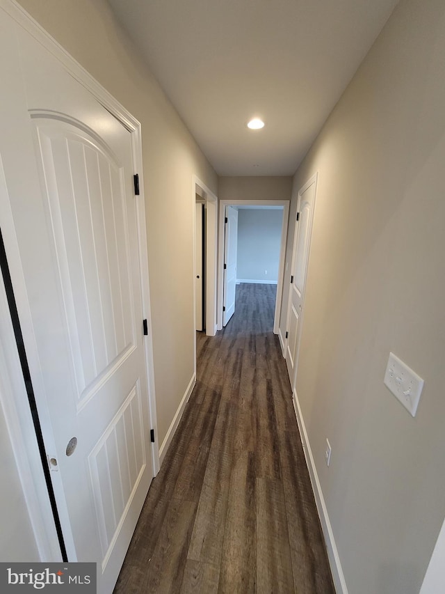 hallway with dark hardwood / wood-style floors