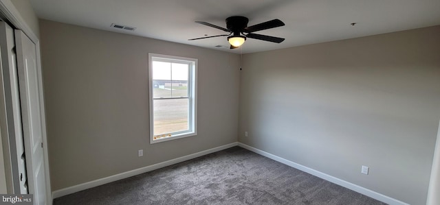 carpeted spare room with ceiling fan