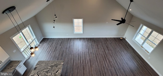 unfurnished living room featuring dark wood-type flooring, high vaulted ceiling, and ceiling fan