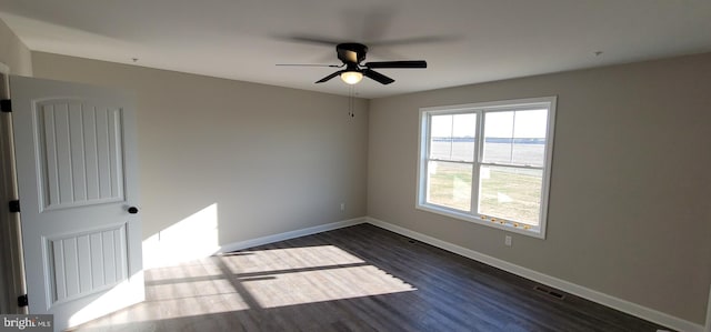 spare room featuring ceiling fan, a water view, and dark hardwood / wood-style flooring