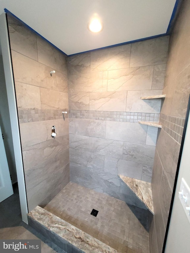 bathroom with tiled shower