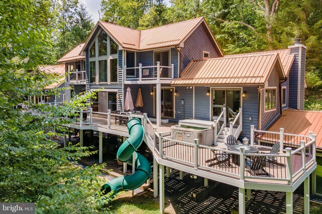 rear view of property featuring a wooden deck